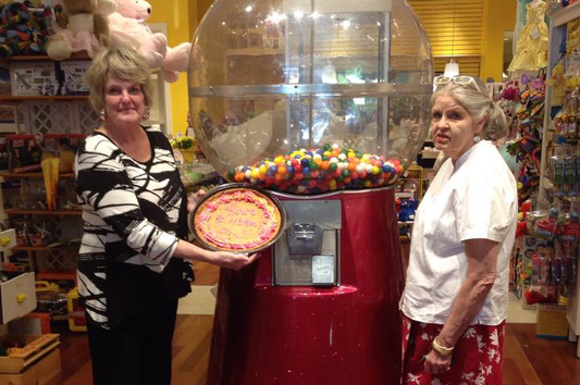 Image of founders in front of gumball machine